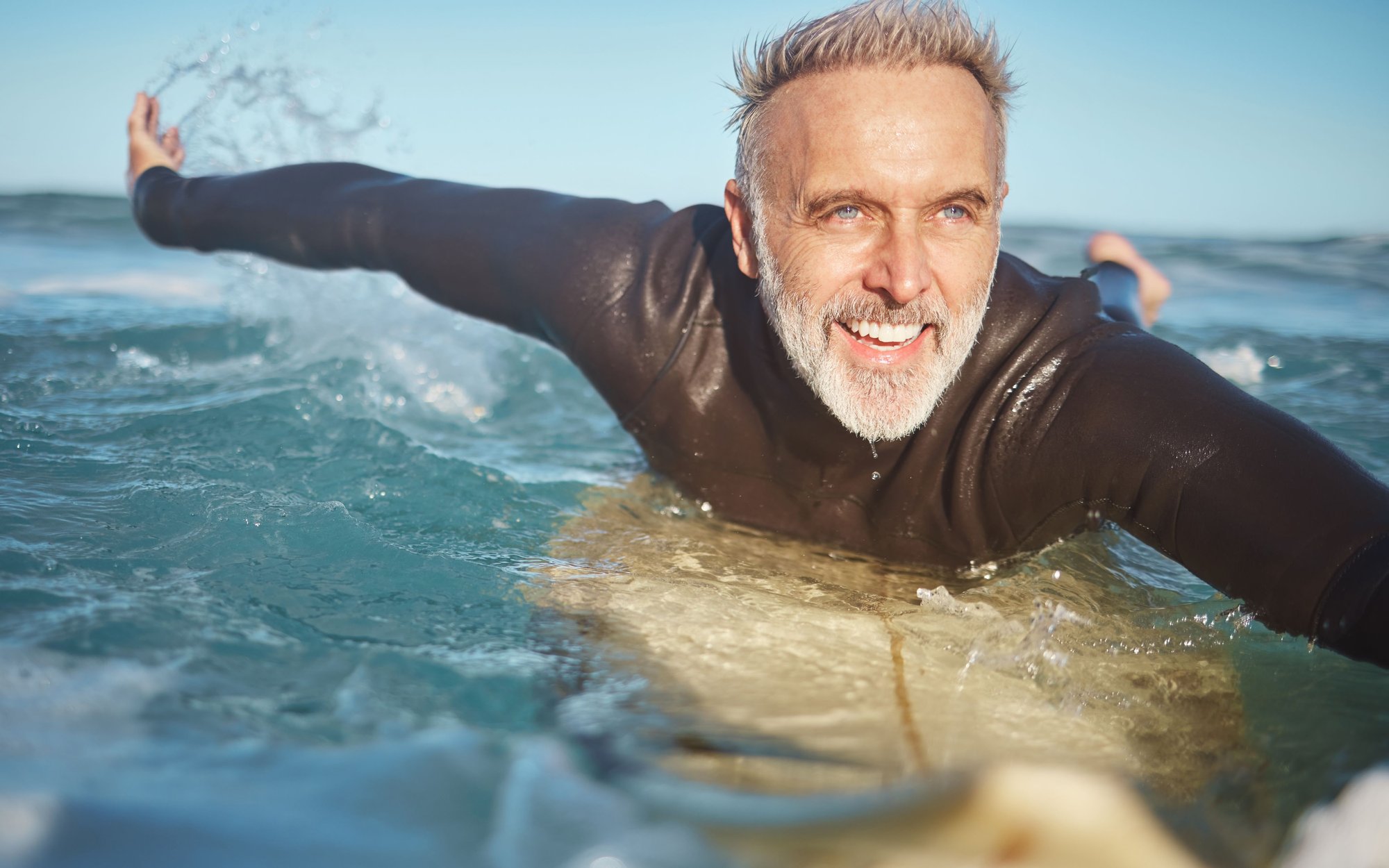 beach-water-and-old-man-surfer-swimming-on-a-summ-2023-11-27-05-09-35-utc